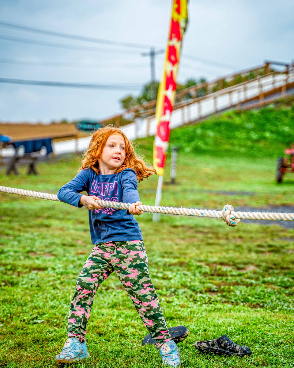 a girl at the tug of war attraction