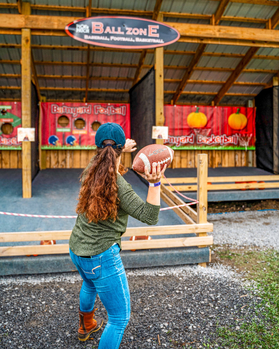 a woman throwing a football at the ball zone