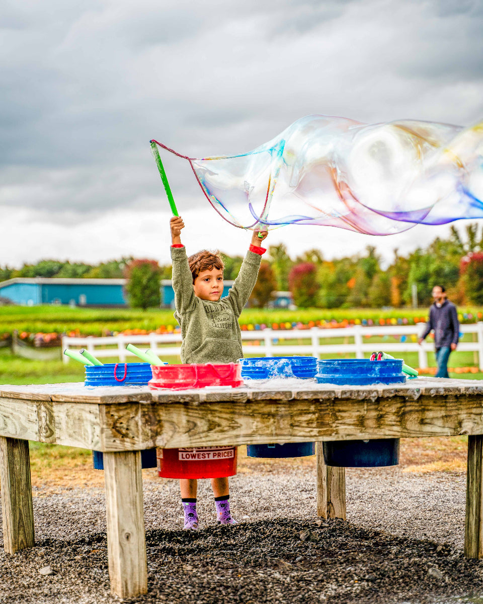 a kid blowing a massive bubble