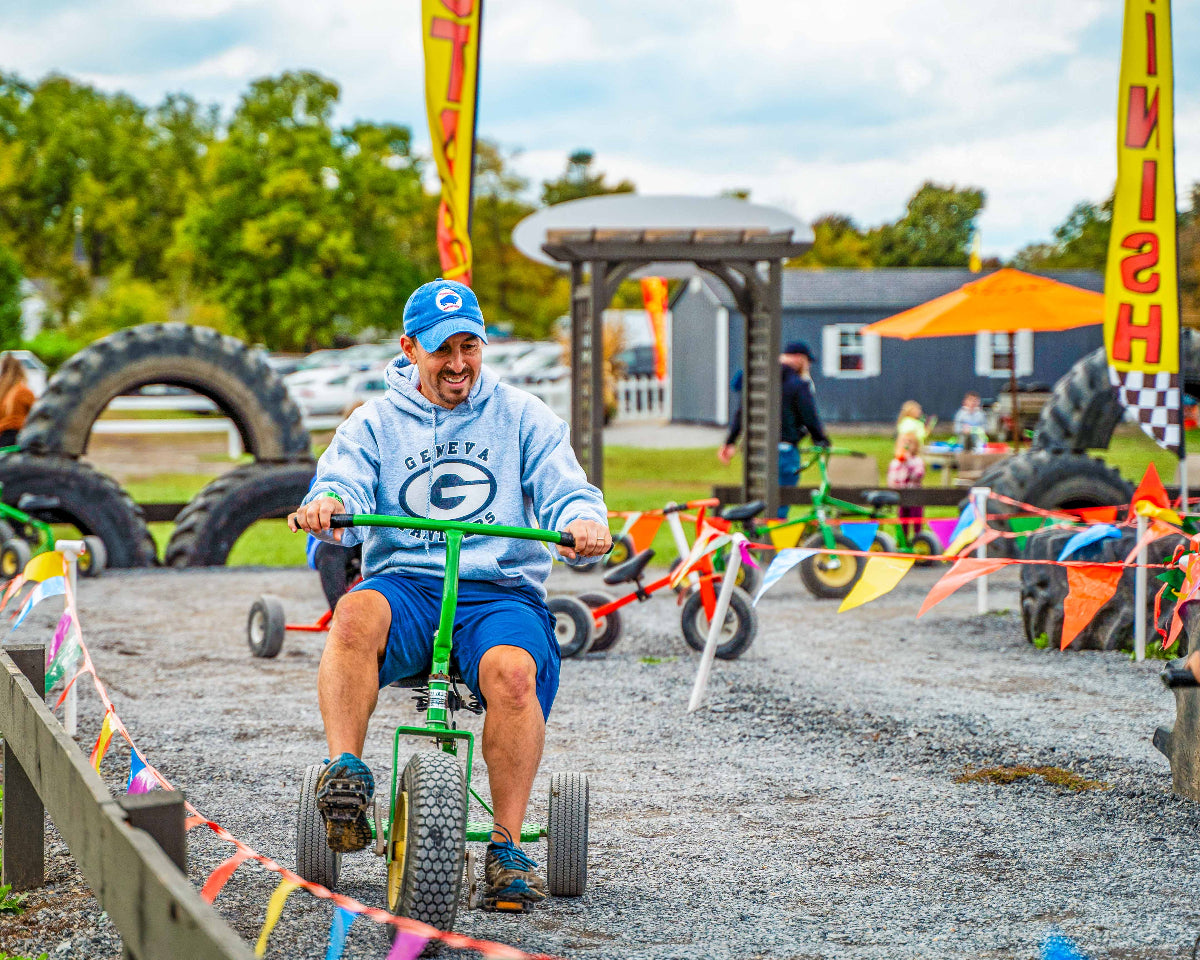 a man riding a trike and smiling